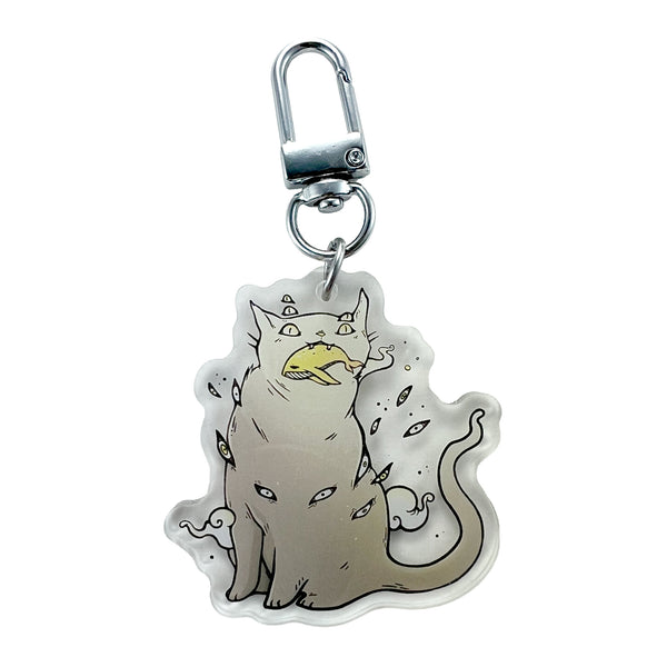 Cat & Whale, Keychain featuring a whimsical cat illustration with multiple eyes and a mysterious design.