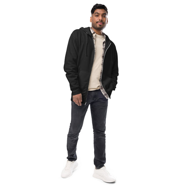 Man wearing a black jacket, white shirt, dark jeans, and white sneakers on a white background