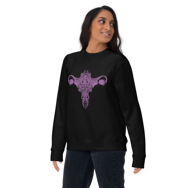 Model wearing a premium unisex sweatshirt featuring a purple Death Metal Uterus design on a black background.