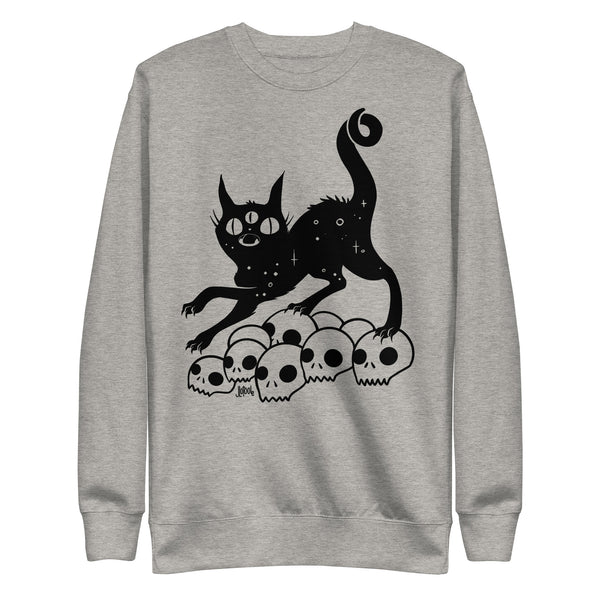 Cat on skulls sweatshirt featuring original illustration, soft cozy fabric, unisex design, ideal for comfort and style.