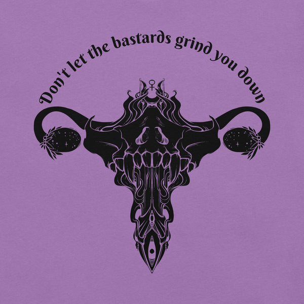 Graphic tee featuring a uterus and ovaries design with the phrase "Don't let the bastards grind you down".