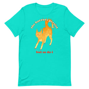 Unisex T-shirt featuring an illustration of a fire cat with the quote 'the horrors persist but so do i' in bright colors.