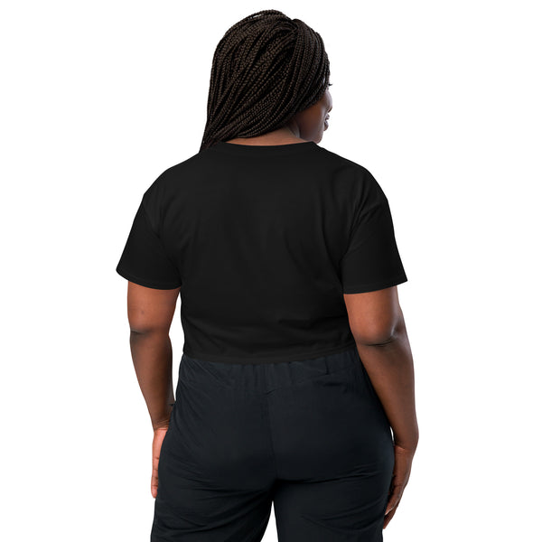 Back view of a model wearing a black relaxed crop top, showcasing its casual and comfortable fit.