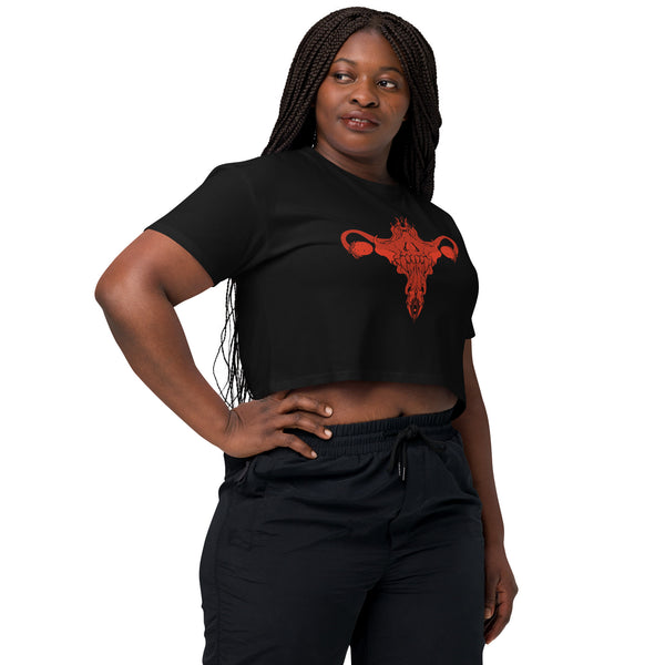 Black relaxed crop top featuring red death metal uterus design, perfect for alt or witchy aesthetics, worn by a woman in a casual pose.