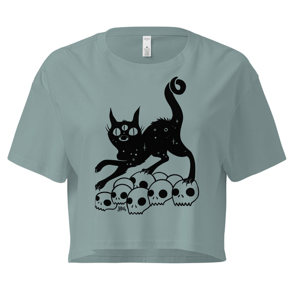 Black crop top featuring a hand-drawn illustration of a black cat on a pile of skulls, relaxed fit, comfortable style.