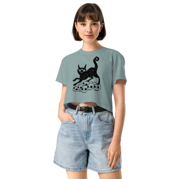 Black cat illustration on skulls featured on a relaxed crop top, made of soft combed cotton, perfect for casual outfits.