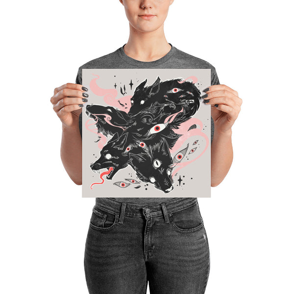 Person holding a matte art print featuring black wolves and eye designs, showcasing original illustration details.