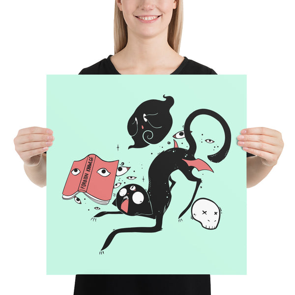 Kuro black cat matte art print poster held by a person, featuring quirky illustrations and vibrant colors.