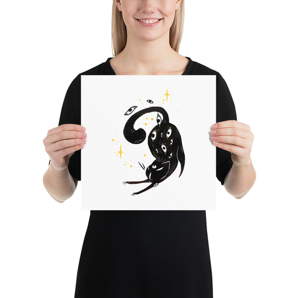 Matte art print of a stretching black cat held by a woman, featuring whimsical details and golden stars.