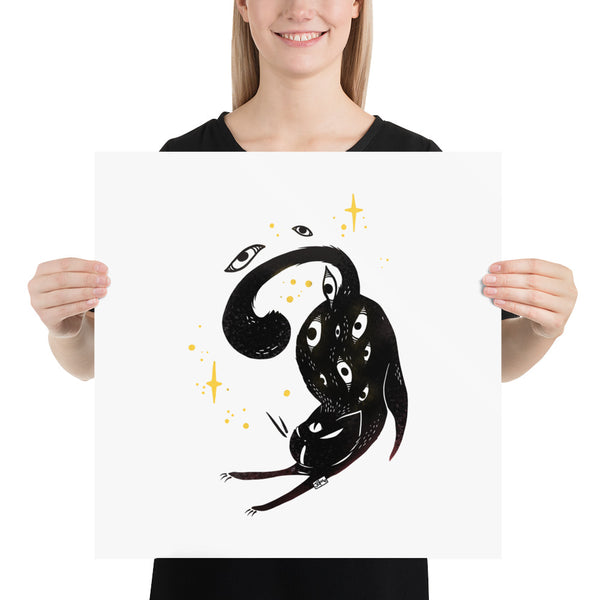 Stretching black cat art print poster held by a woman, featuring a whimsical illustration with stars and eyes.